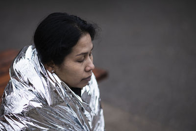 Woman wrapped in emergency blanket
