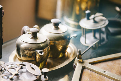 Close-up of tea kettles in kitchen