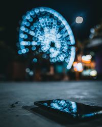 Close-up of illuminated ferris wheel at night