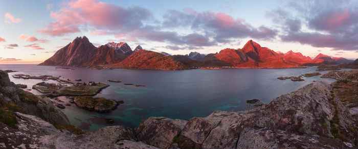 Panoramic view of sea and mountains against sky during sunset
