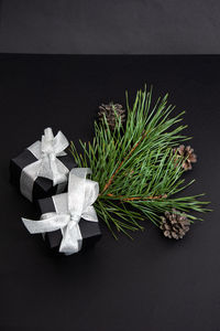 Close-up of christmas decoration on table against black background