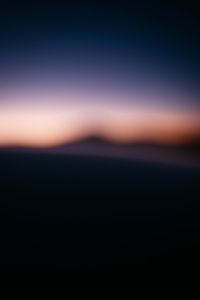 Defocused image of sea against clear sky