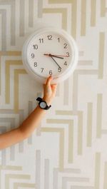 Close-up of woman hand holding clock