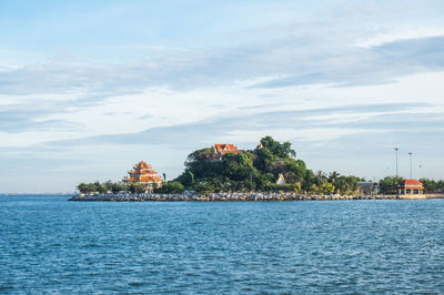 Scenic view of sea by building against sky