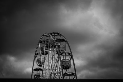 Low angle view of ferris wheel against sky