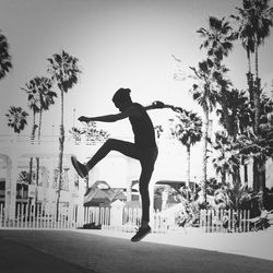 Full length of woman jumping in water