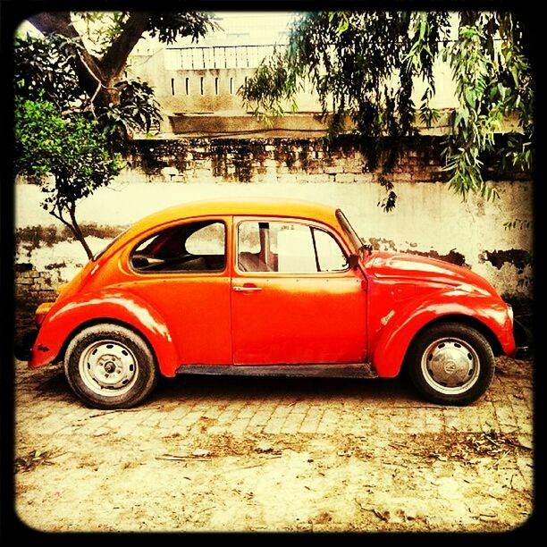 transportation, land vehicle, mode of transport, car, transfer print, auto post production filter, red, street, tree, stationary, travel, road, outdoors, side view, day, vintage car, parking, no people, on the move, sunlight