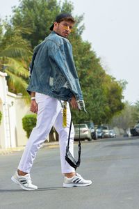 Full length portrait of man standing on street in city