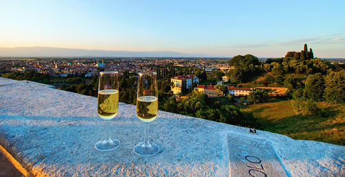 Two wineglasses against italian cityscape