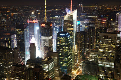 Aerial view of illuminated buildings in city at night