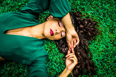 High angle view of baby girl lying on grass