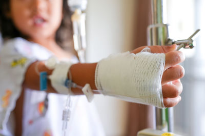 Girl with iv infusion on her hand