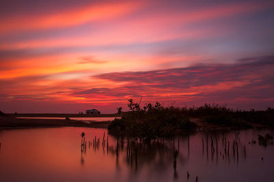 Scenic view of lake against romantic sky at sunset