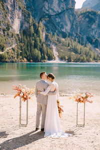 Rear view of couple with mother in water