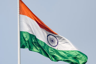 India flag flying high at connaught place with pride in blue sky, india flag fluttering, indian flag