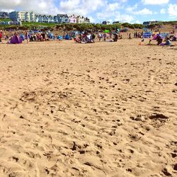 People on beach against sky