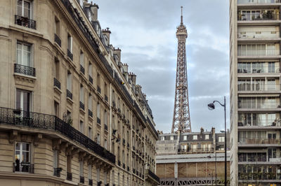 Low angle view of buildings against cloudy sky