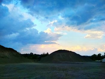 Scenic view of field against sky at sunset