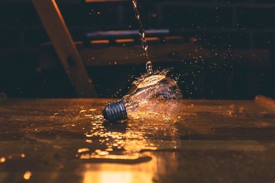 Water falling on light bulb