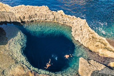 High angle view of rocks on sea shore