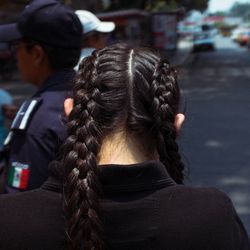 Rear view of woman on street in city