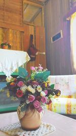 Close-up of flower vase on table at home