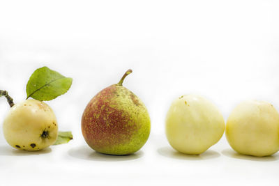 Close-up of apples and fruits on white background