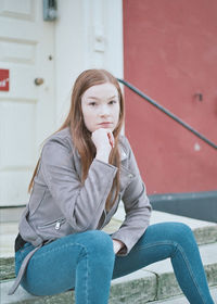 Young woman sitting outdoors