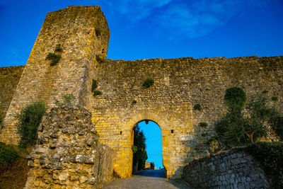 Old ruin building against blue sky