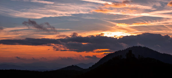 Scenic view of silhouette mountains against sky during sunset