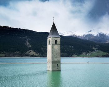 Church by sea against sky