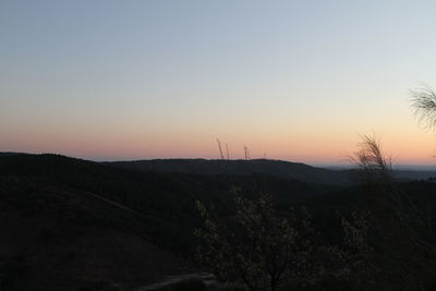 Scenic view of silhouette mountains against clear sky