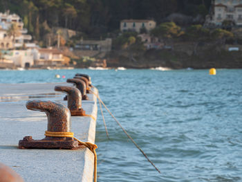 Mooring pin for medium size boat. rusty bent mooring bollard in a port.