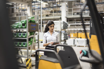 Woman using tablet in factory shop floor