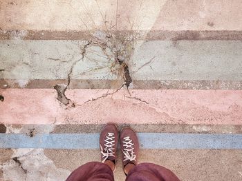 Low section of person standing on footpath