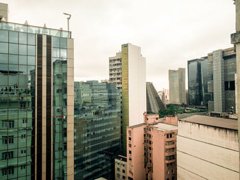 Modern buildings in city against sky