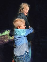 Mother and son standing on shore