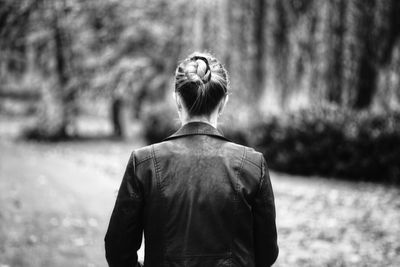 Side view of woman standing in forest