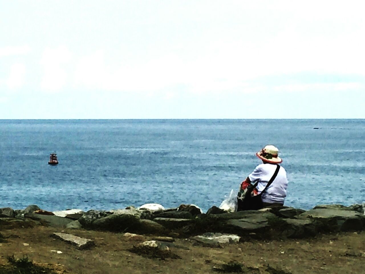 MAN ON SHORE AGAINST SKY