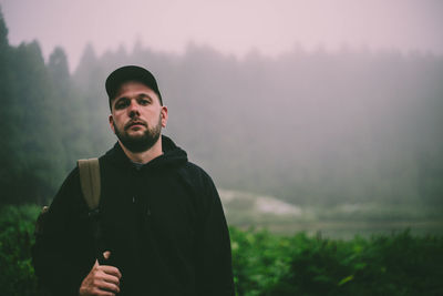 Portrait of young man standing on land