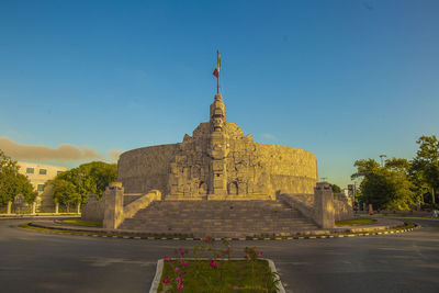 Low angle view of temple against clear blue sky