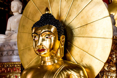 Sculpture of buddha statue in temple outside building