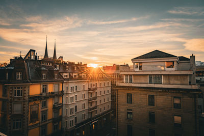 Morning light peaking on top of the rooftops of old city buildings