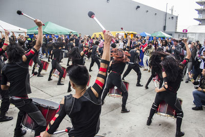 Crowd looking at performers performing on street