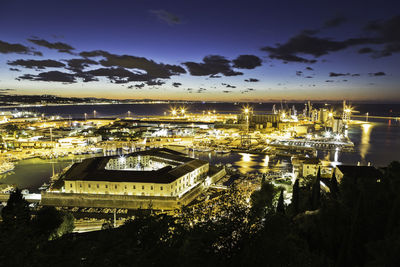 High angle view of illuminated buildings in city at night