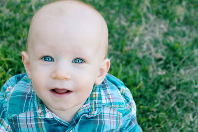 Portrait of cute boy smiling on field