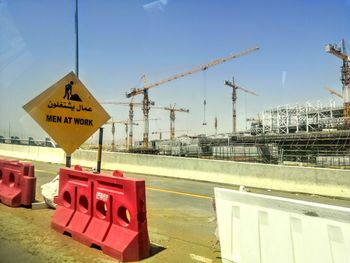 Information sign at construction site against sky