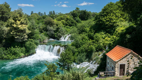 Scenic view of waterfall against sky