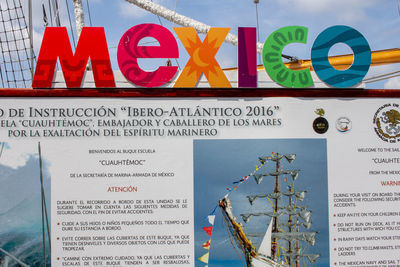 Low angle view of information sign against sky