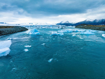 Scenic view of icebergs in jokulsarlon glacier lagoon, iceland, at dusk.